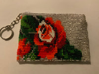 Handcrafted beadwork on both sides of change purse with flower